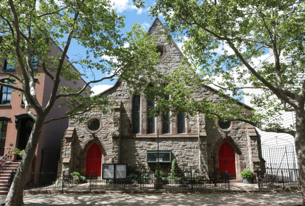 Gothic church with pointed roof and red doors