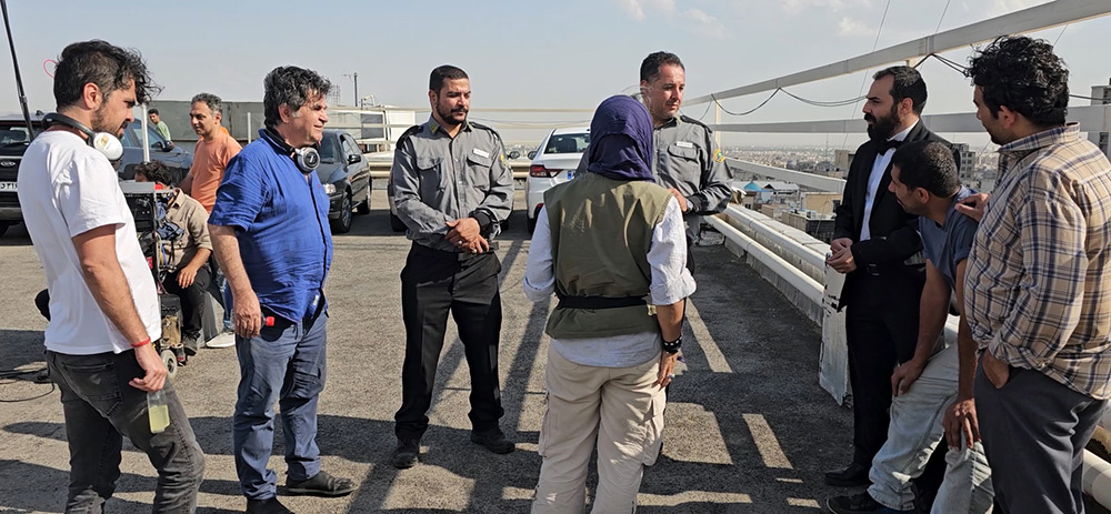 Panahi, in blue, on the set of It Was Just an Accident