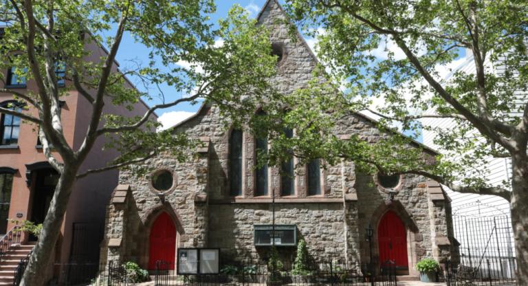 Gothic church with pointed roof and red doors