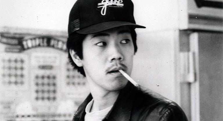 Chan with a cigarette in his mouth.